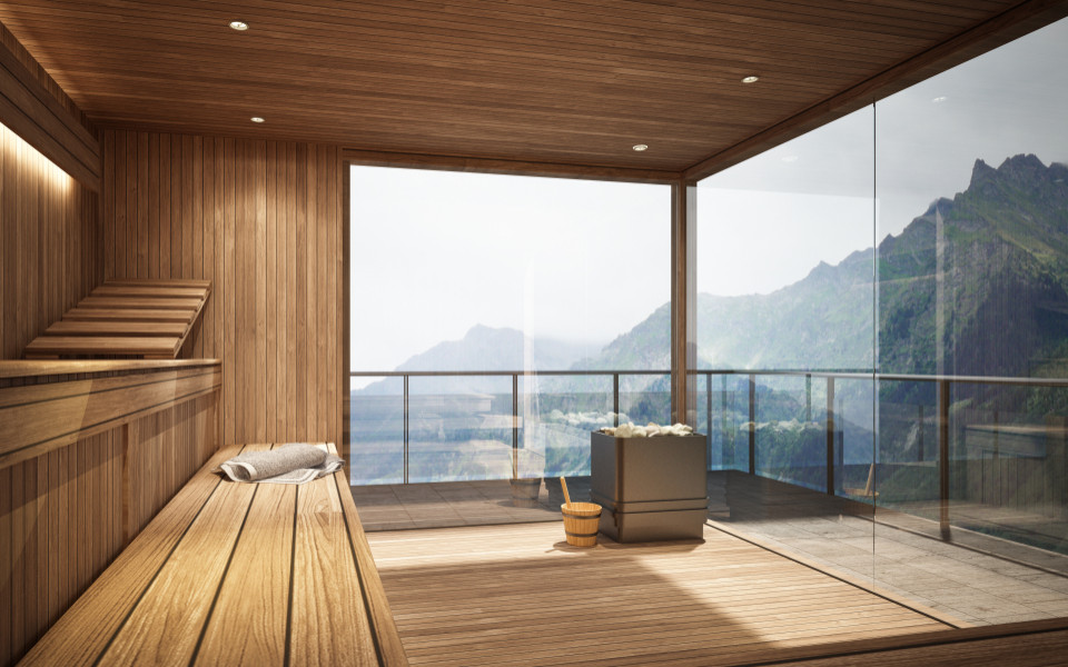 Sauna aus Holz mit gro&szlig;en Fenstern, die einen Blick auf die Berge des Berchtesgadener Landes erm&ouml;glichen, ausgestattet mit einem Holzofen und einem Eimer samt Holzl&ouml;ffel.